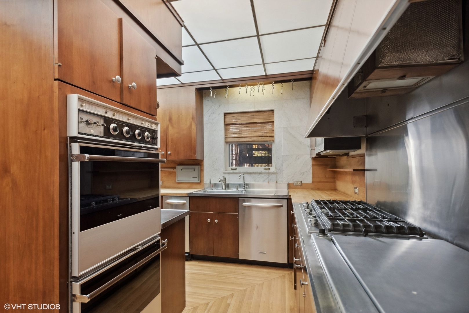 43 East Elm Street Chicago, IL 60611 - Photo 6 of 17 a kitchen with stainless steel appliances granite countertop a stove and a sink