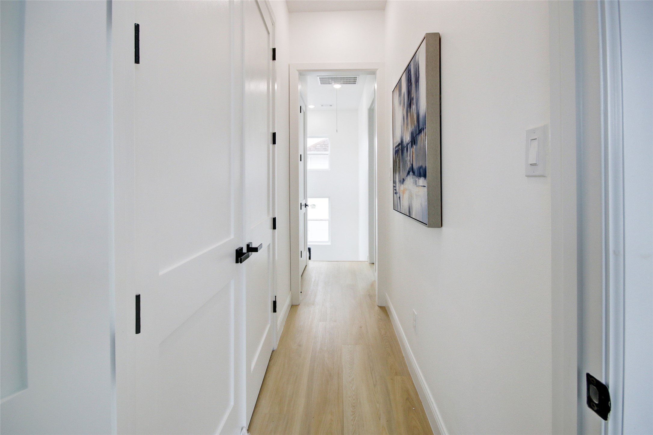 1214 West 24th Street, Unit D Houston, TX 77008 - Photo 35 of 45 a view of a hallway with wooden floor and a bathroom