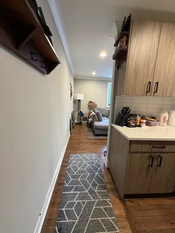 a kitchen with sink cabinets and living room view