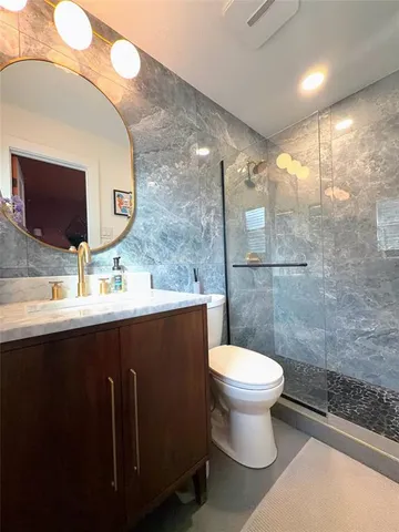 a bathroom with a sink toilet and a mirror