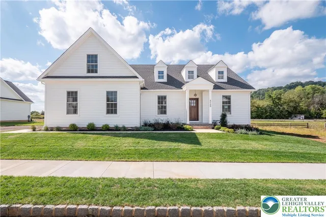 a view of a big house with a big yard and potted plants
