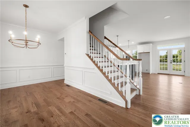 a view of an entryway with wooden floor