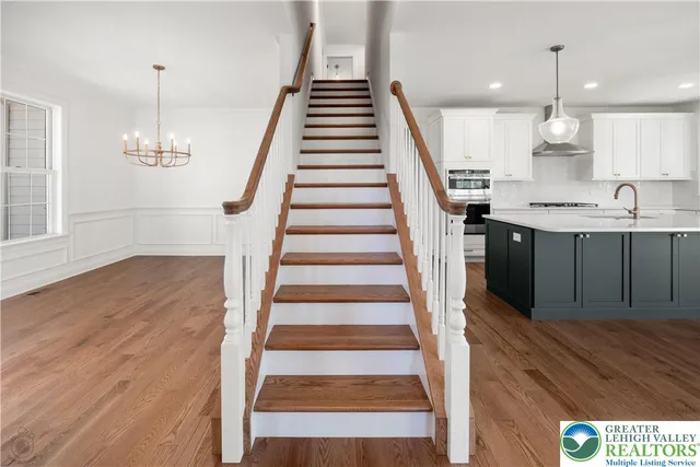 a view of entryway and hall with wooden floor