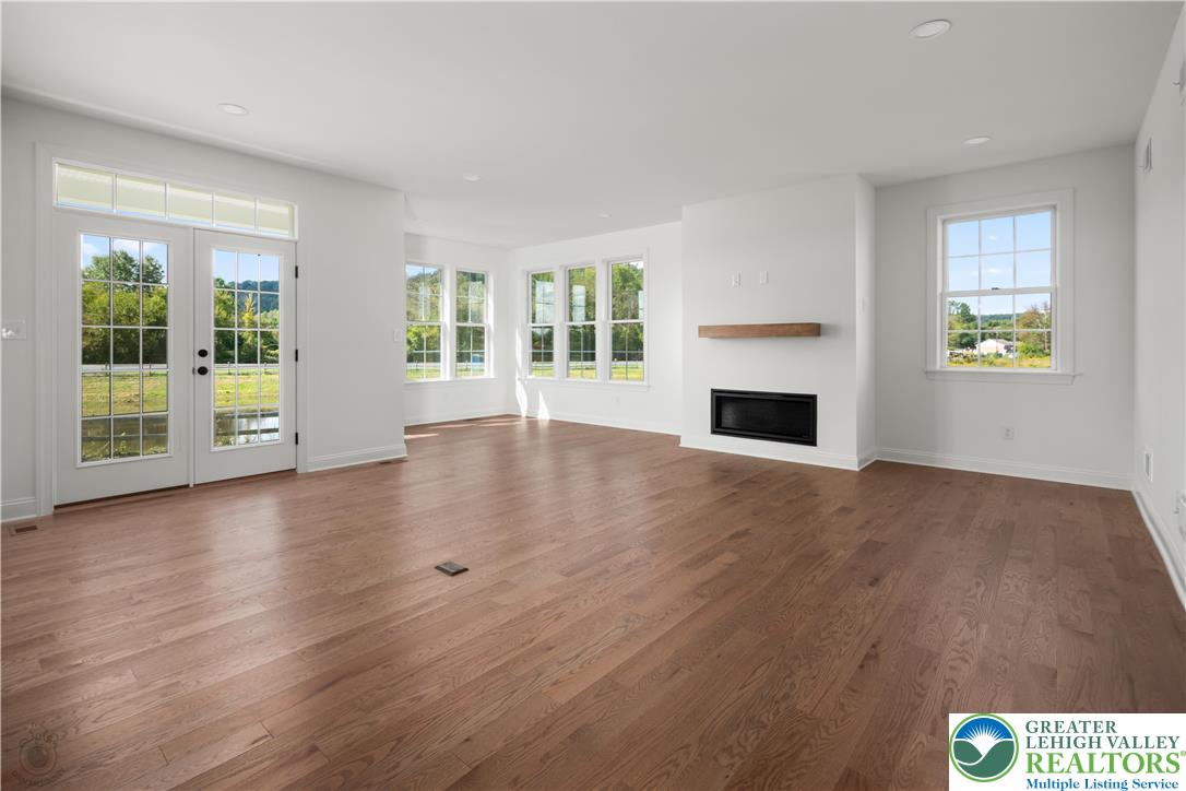 4268 Stonebridge Drive Bethlehem, PA 18015 - Photo 18 of 37 an empty room with windows wooden floor and windows