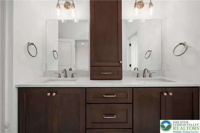 a bathroom with a sink double vanity and a mirror