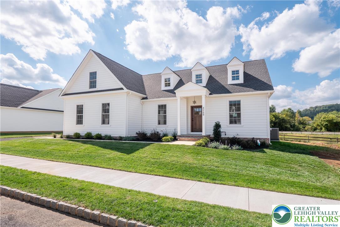 4268 Stonebridge Drive Bethlehem, PA 18015 - Photo 4 of 37 a front view of a house with a yard