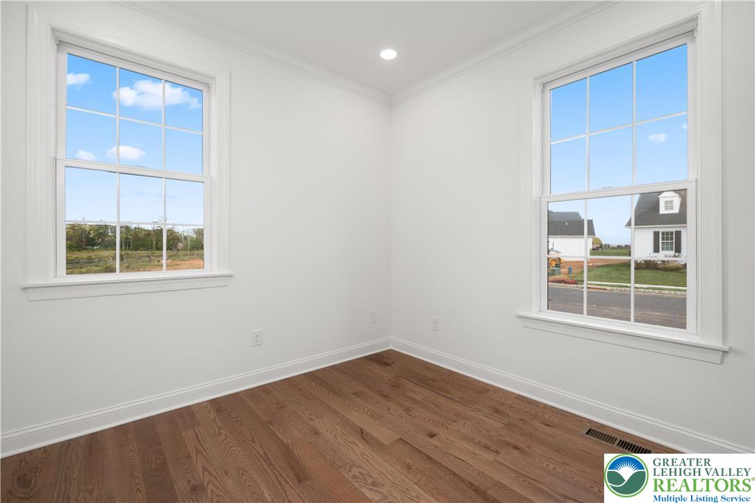 4268 Stonebridge Drive Bethlehem, PA 18015 - Photo 9 of 37 a view of an empty room with wooden floor and a window