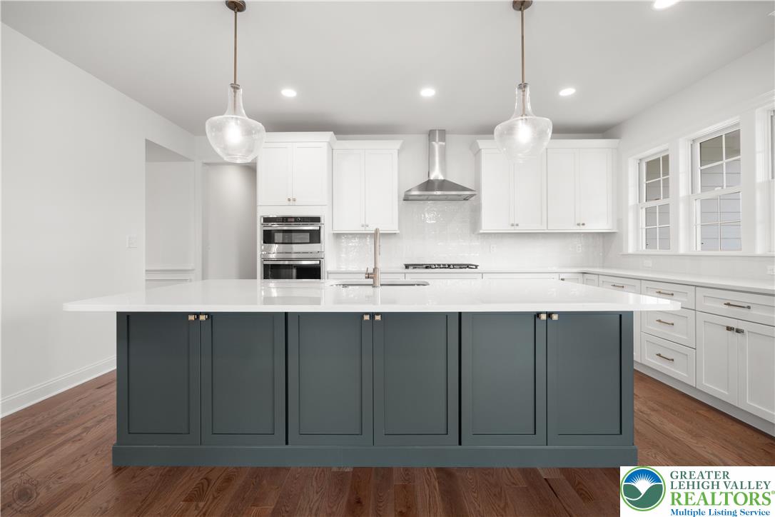 4268 Stonebridge Drive Bethlehem, PA 18015 - Photo 10 of 37 a kitchen with kitchen island stainless steel appliances a large counter space a sink and cabinets