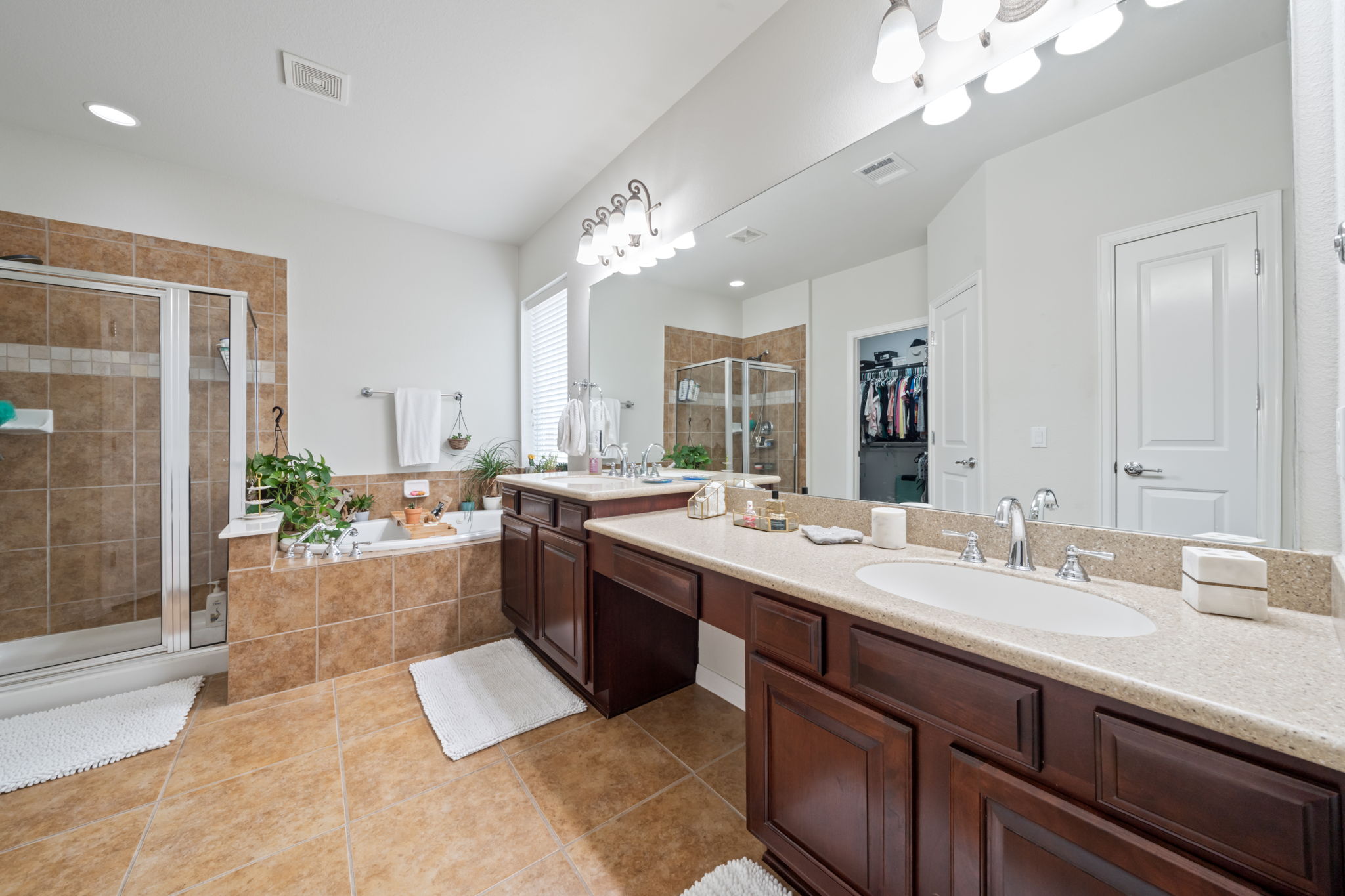 1581 Grassy Field Road Austin, TX 78737 - Photo 21 of 37 Warm tile flooring and a double vanity define this spacious bath featuring a separate tub.