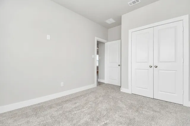 an empty room with closet area