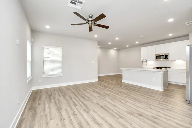 a view of kitchen with cabinets and wooden floor