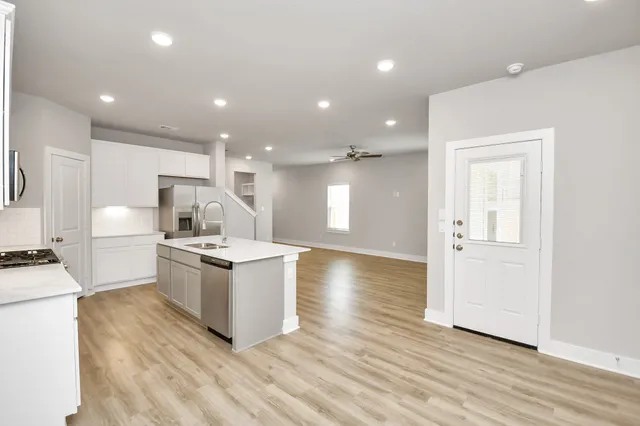 a kitchen with a sink and a stove top oven