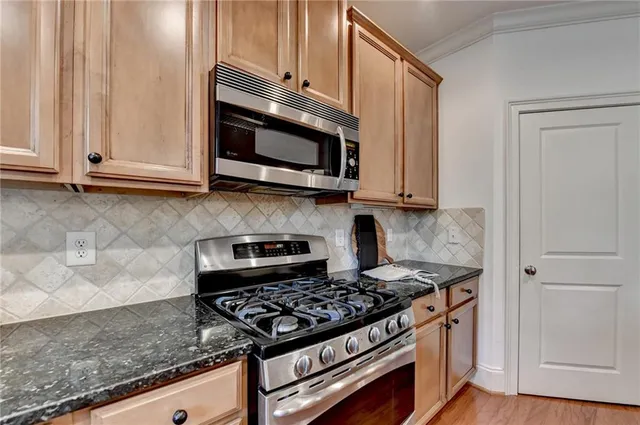 a living room with furniture a bookshelf and a window
