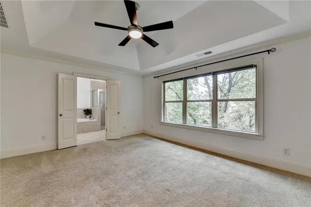 a view of empty room with ceiling fan