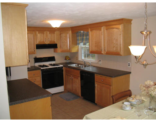 14 Governor Hutchinson Road Billerica, MA 01821 - Photo 4 of 9 a kitchen with stainless steel appliances granite countertop a stove a sink and a microwave