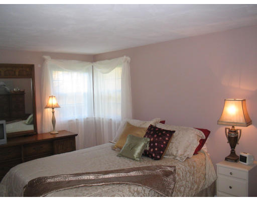 14 Governor Hutchinson Road Billerica, MA 01821 - Photo 7 of 9 a bedroom with a bed and a lamp