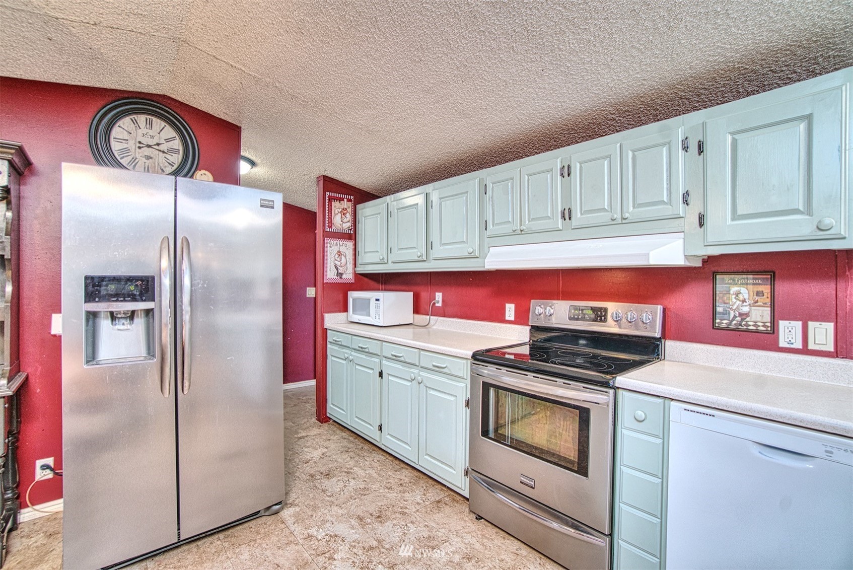 7240 183rd Avenue Southwest Rochester, WA 98579 - Photo 14 of 35 a kitchen with stainless steel appliances granite countertop a stove a refrigerator and a refrigerator