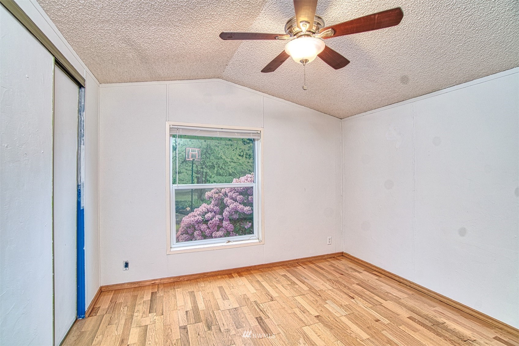 7240 183rd Avenue Southwest Rochester, WA 98579 - Photo 23 of 35 an empty room with fan and windows