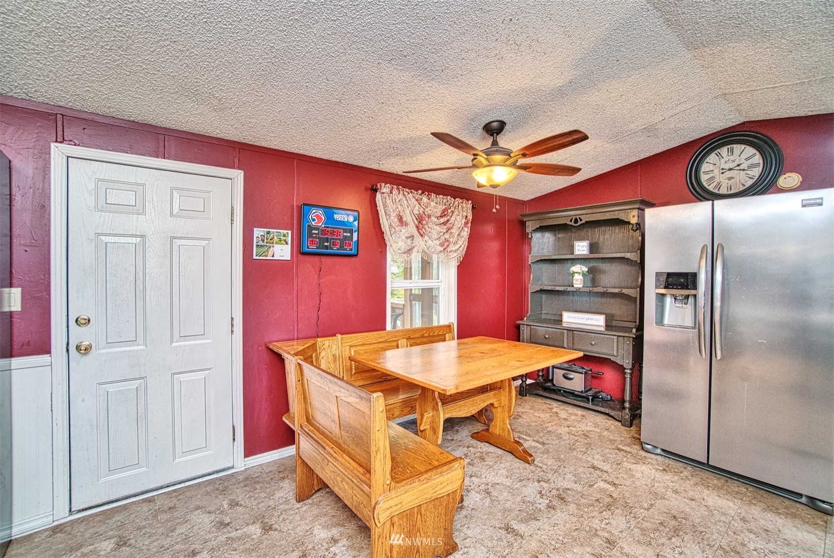 7240 183rd Avenue Southwest Rochester, WA 98579 - Photo 10 of 35 a kitchen with stainless steel appliances kitchen island granite countertop a refrigerator a stove and a dining table with painted walls