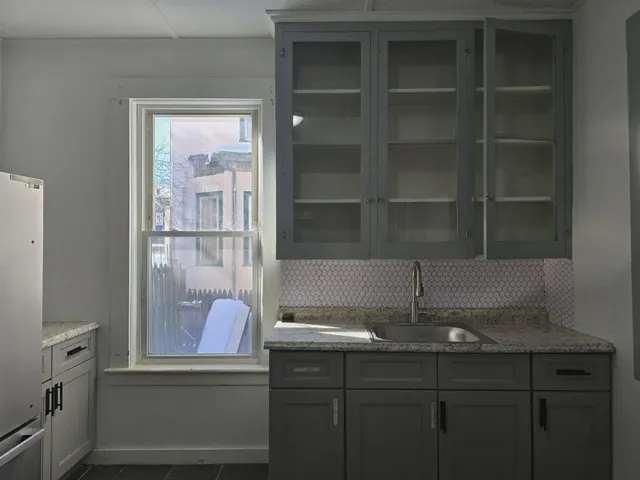 a kitchen with a sink and cabinets
