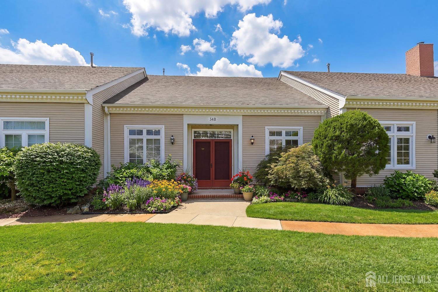 34 Rutland Lane, Unit B Monroe Township, NJ 08831 - Photo 1 of 45 a front view of a house with a garden