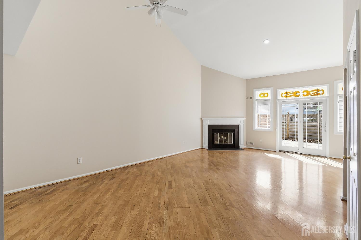 34 Rutland Lane, Unit B Monroe Township, NJ 08831 - Photo 11 of 45 a view of an empty room with a fireplace and a window