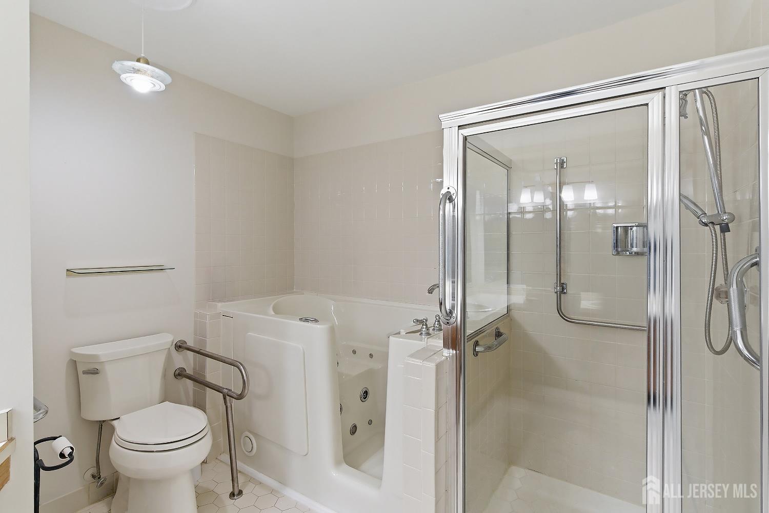 34 Rutland Lane, Unit B Monroe Township, NJ 08831 - Photo 18 of 45 a bathroom with a granite countertop toilet and a shower