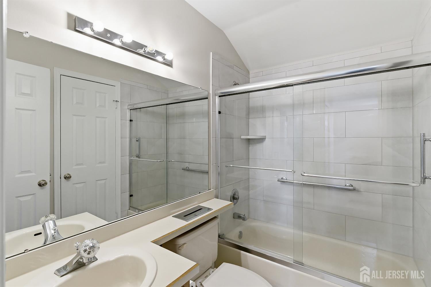 34 Rutland Lane, Unit B Monroe Township, NJ 08831 - Photo 24 of 45 a bathroom with a sink mirror and shower