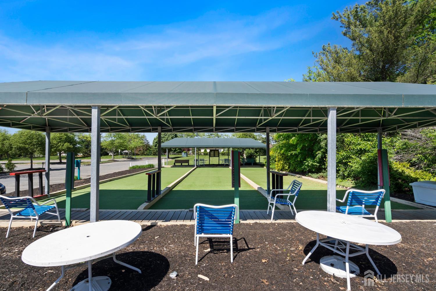34 Rutland Lane, Unit B Monroe Township, NJ 08831 - Photo 41 of 45 a view of a patio with a table chairs and a backyard