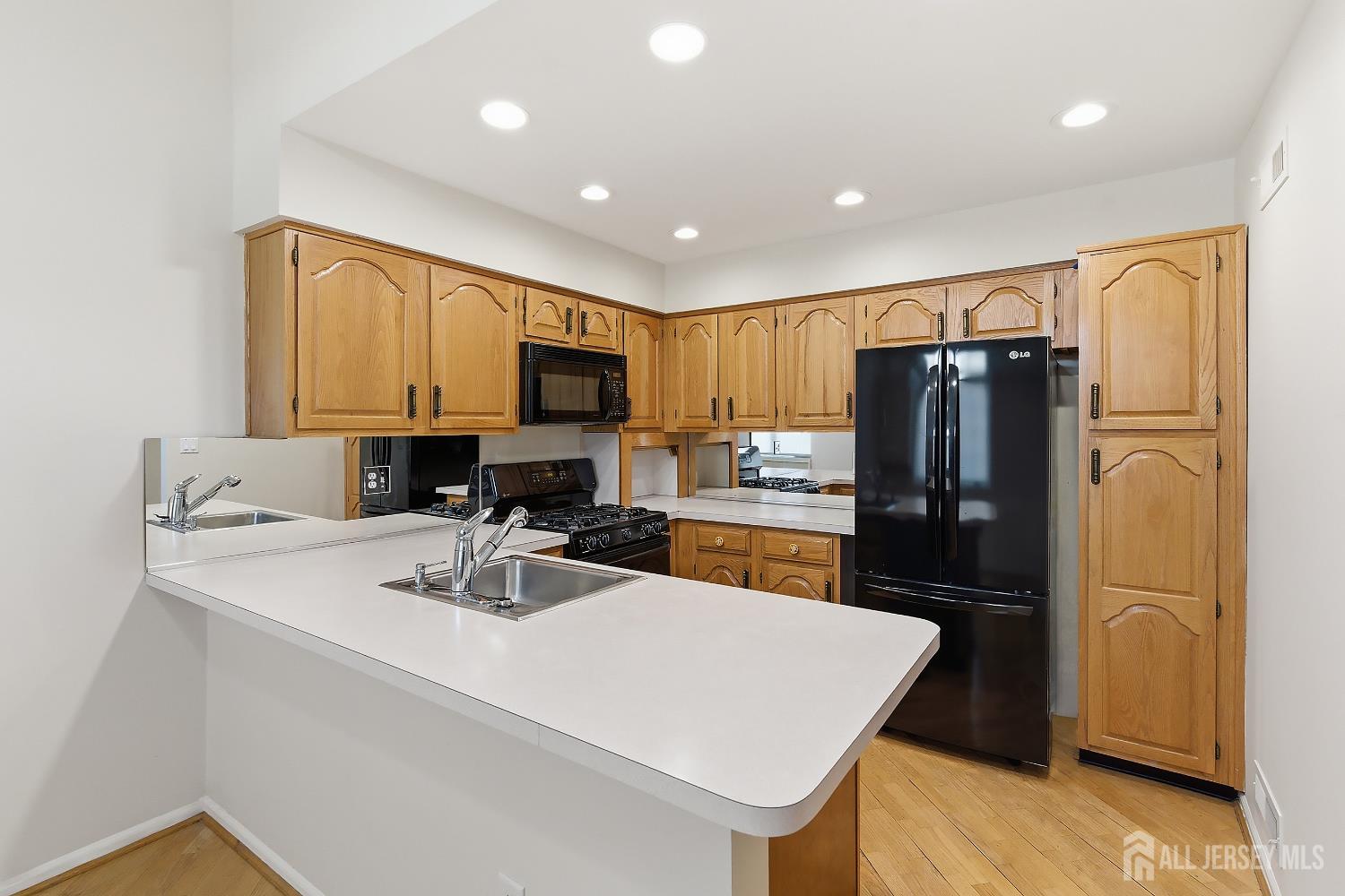 34 Rutland Lane, Unit B Monroe Township, NJ 08831 - Photo 7 of 45 a kitchen with stainless steel appliances a refrigerator sink and microwave
