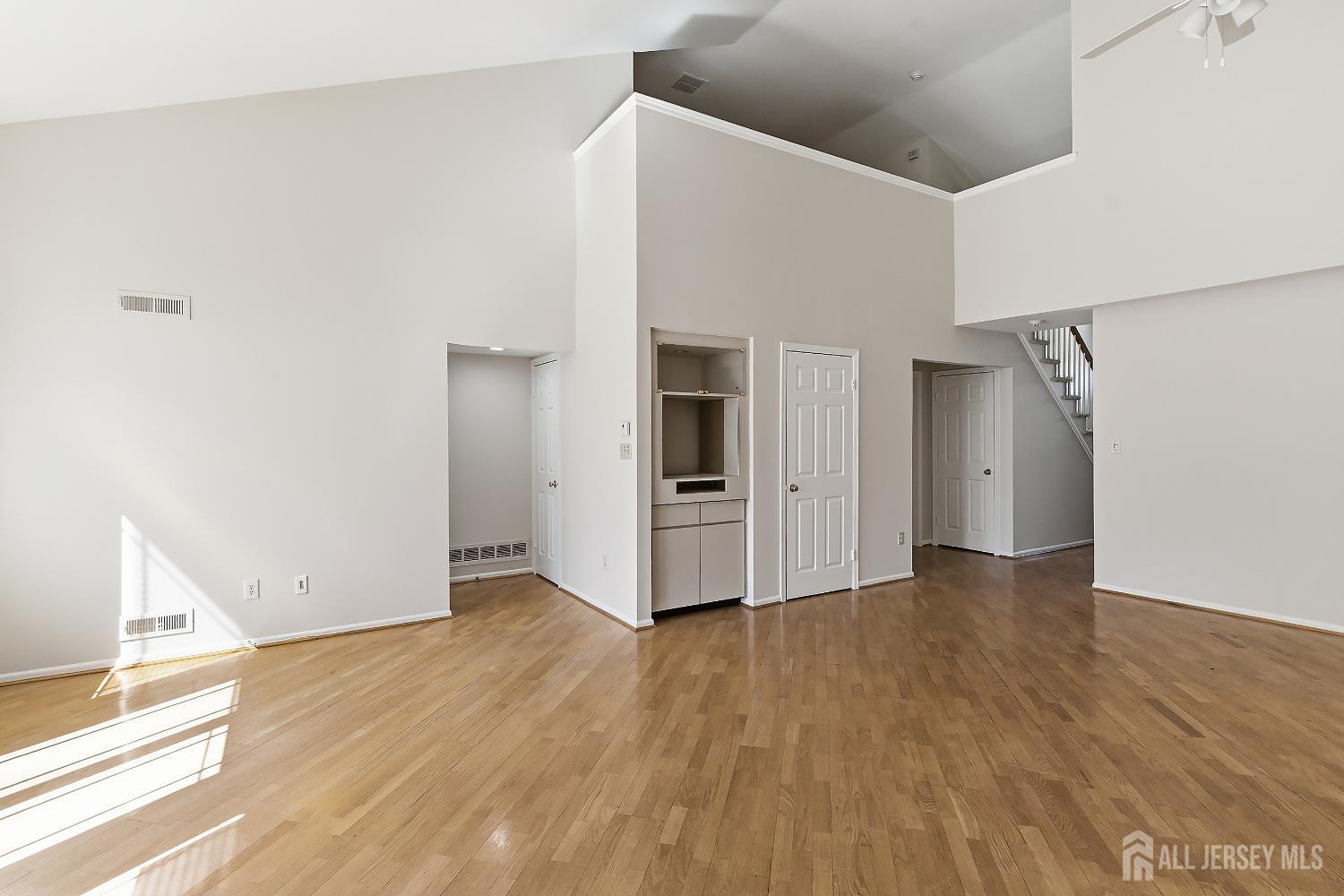 34 Rutland Lane, Unit B Monroe Township, NJ 08831 - Photo 10 of 45 a view of an empty room with wooden floor and a window