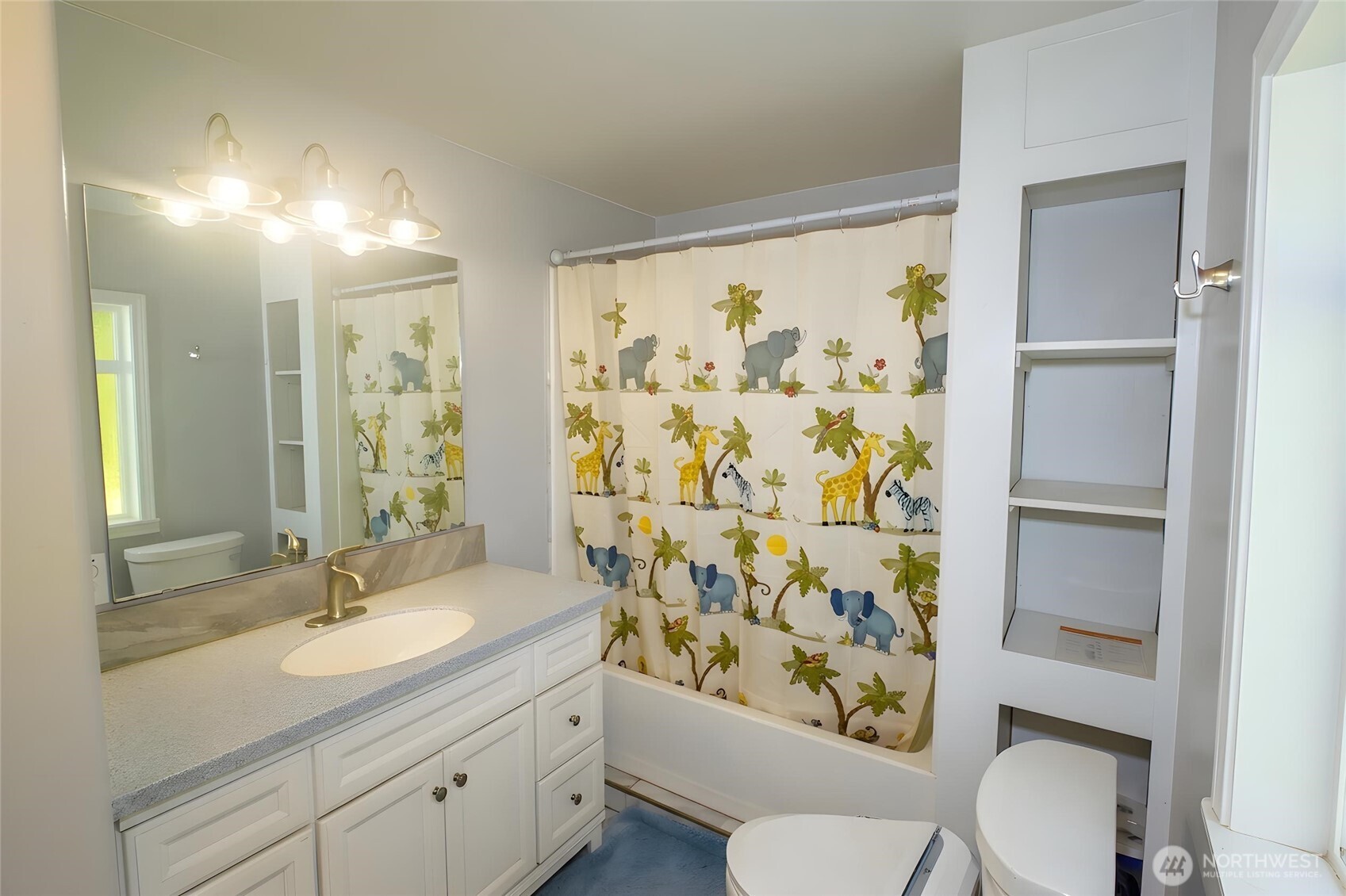 89 Slab Camp Road Sequim, WA 98382 - Photo 20 of 40 a bathroom with a granite countertop sink toilet a mirror and shower curtain