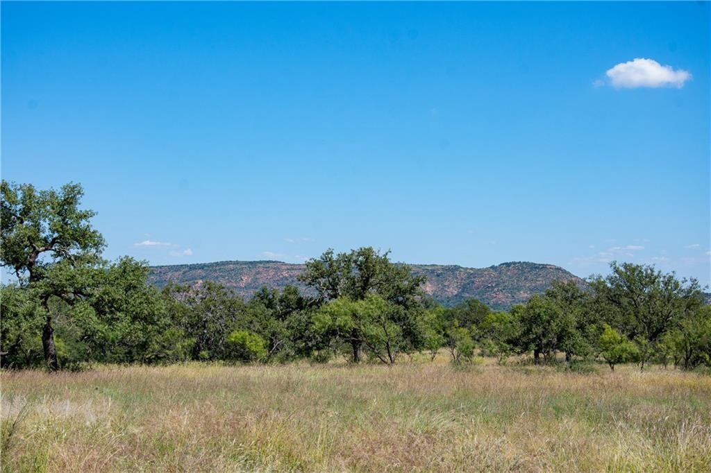 405 County Road 405 Valley Spring, TX 76885 - Photo 9 of 40 a view of a lake with a mountain in the background