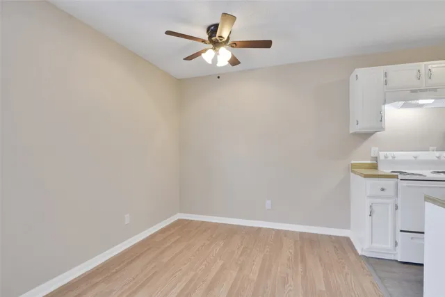 a view of a kitchen with wooden floor and a sink