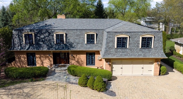 39 Mockingbird Lane Oak Brook, IL 60523 - Photo 1 of 57 a front view of a house with garden