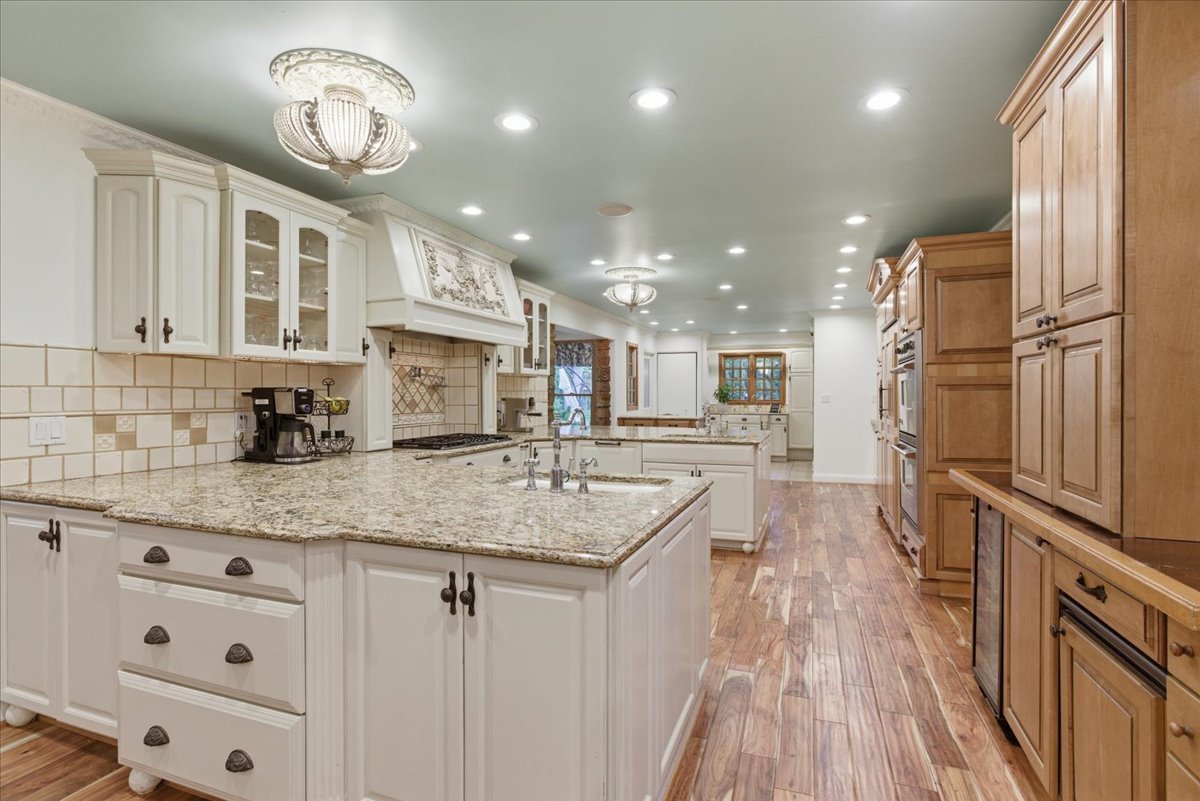 39 Mockingbird Lane Oak Brook, IL 60523 - Photo 13 of 57 a kitchen with stainless steel appliances granite countertop a sink refrigerator and cabinets