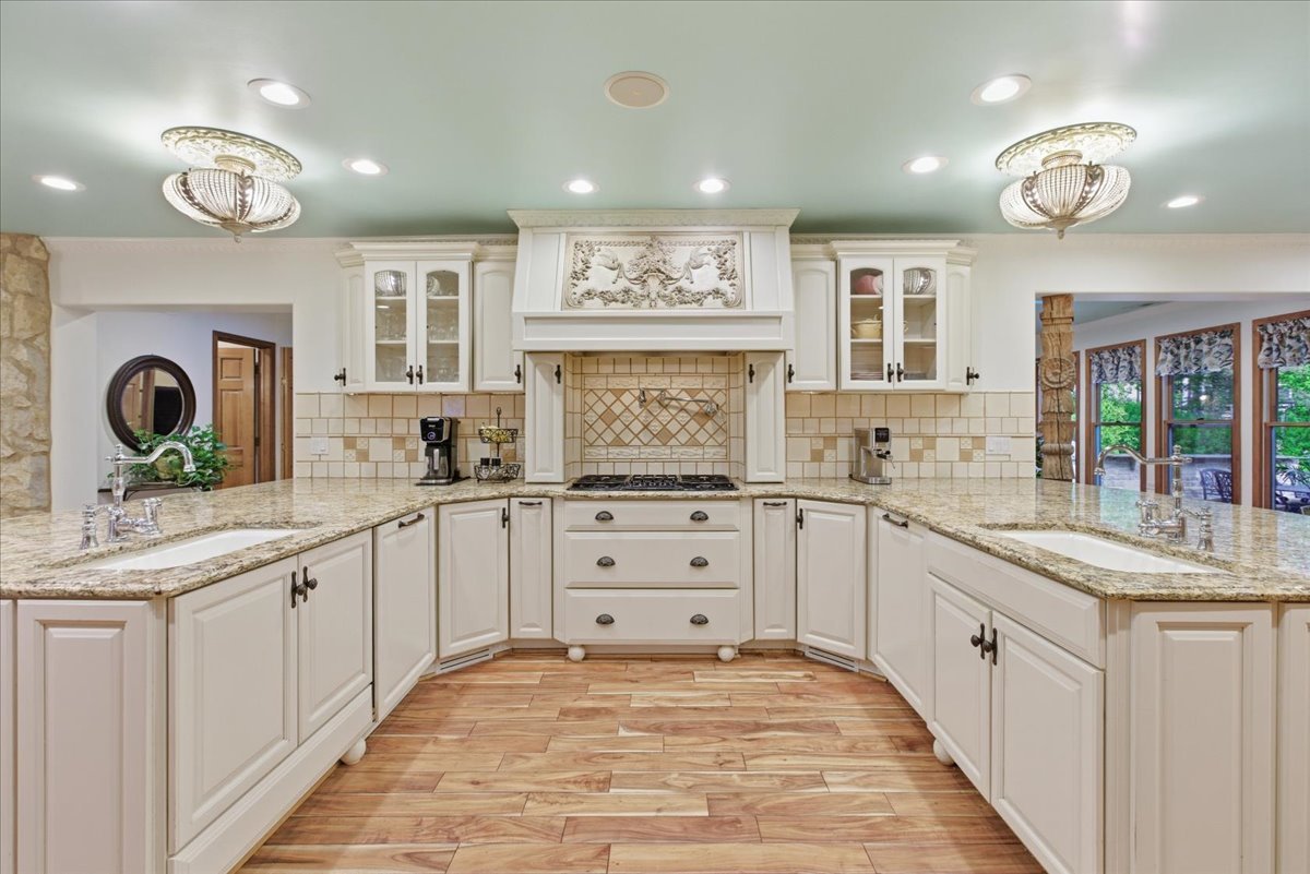 39 Mockingbird Lane Oak Brook, IL 60523 - Photo 14 of 57 a kitchen with kitchen island granite countertop a sink and cabinets