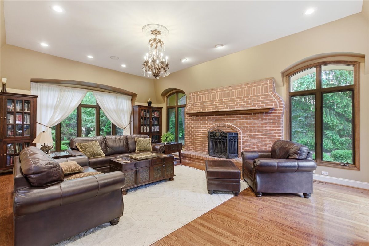 39 Mockingbird Lane Oak Brook, IL 60523 - Photo 18 of 57 a living room with furniture windows and a fireplace
