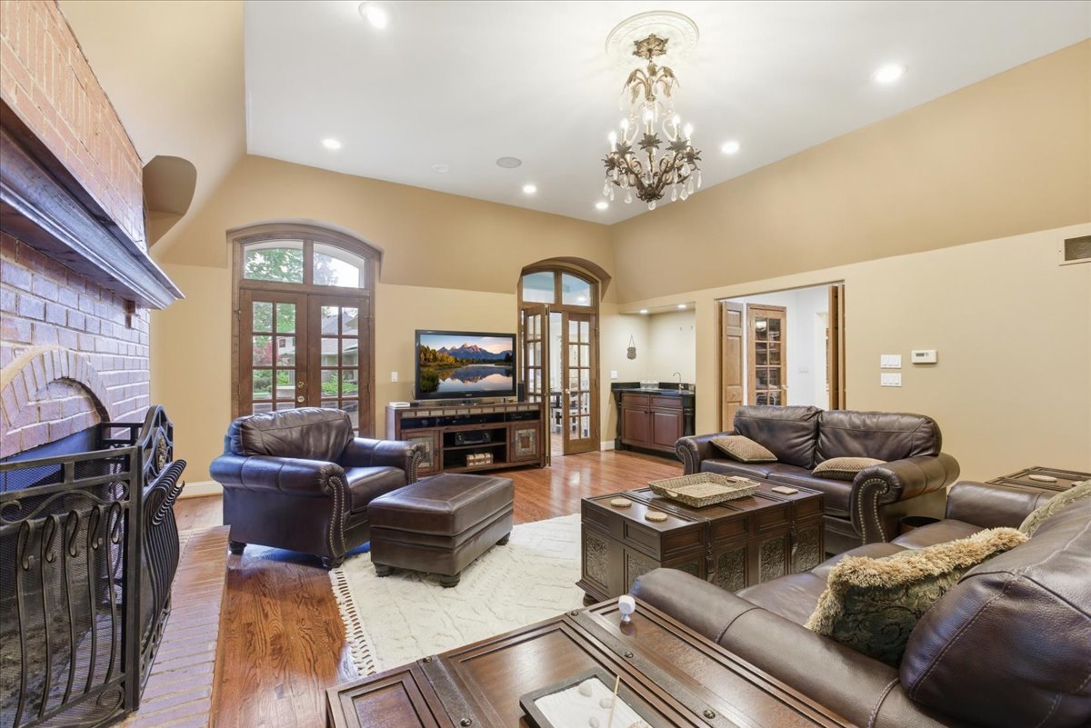39 Mockingbird Lane Oak Brook, IL 60523 - Photo 19 of 57 a living room with furniture a chandelier and a flat screen tv