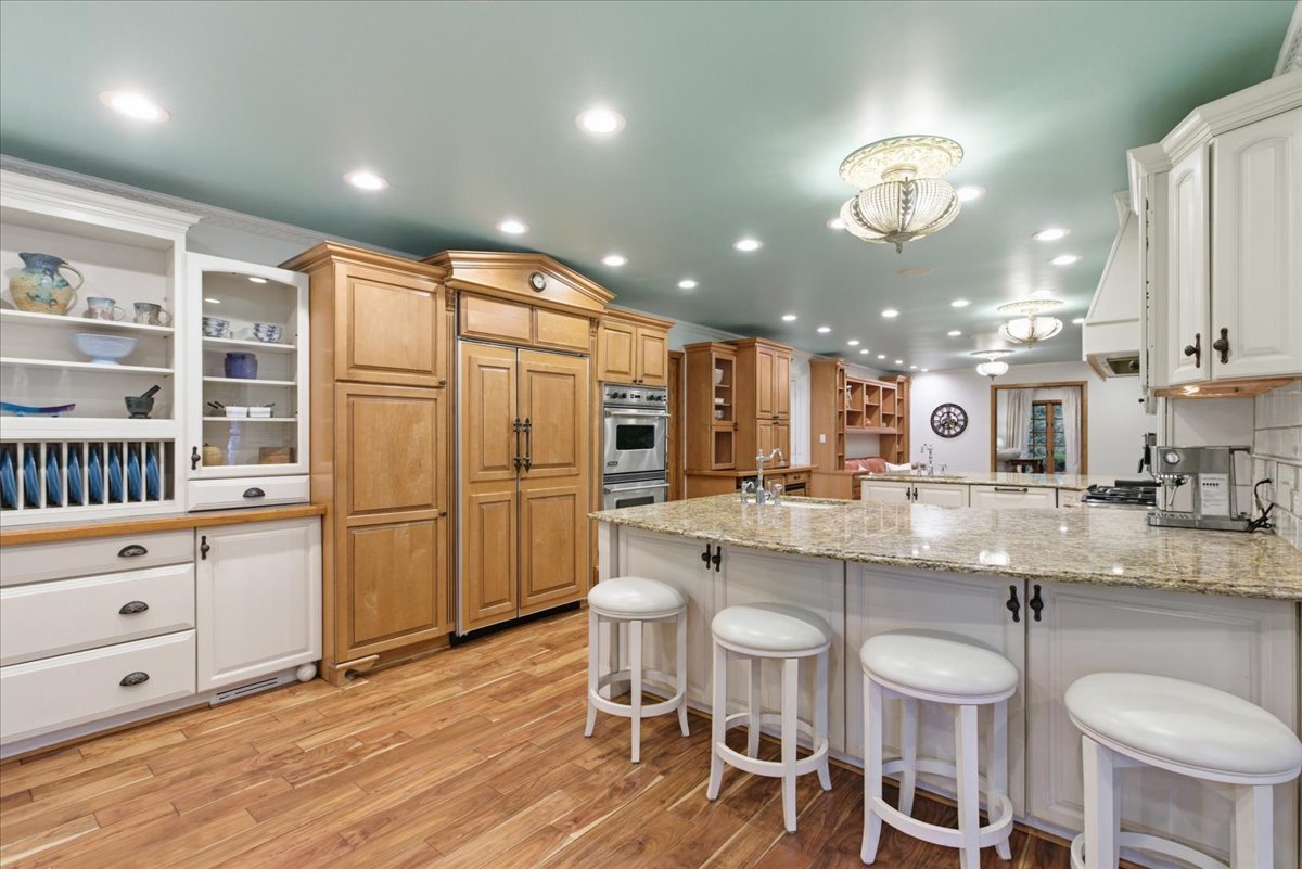 39 Mockingbird Lane Oak Brook, IL 60523 - Photo 21 of 57 a kitchen with stainless steel appliances granite countertop a sink cabinets and wooden floor