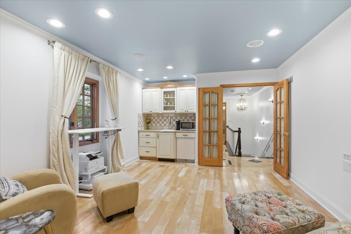 39 Mockingbird Lane Oak Brook, IL 60523 - Photo 26 of 57 a large white kitchen with stainless steel appliances granite countertop a refrigerator oven a sink dishwasher and white cabinets with wooden floor