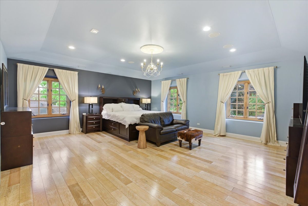 39 Mockingbird Lane Oak Brook, IL 60523 - Photo 27 of 57 a spacious bedroom with a bed and large windows
