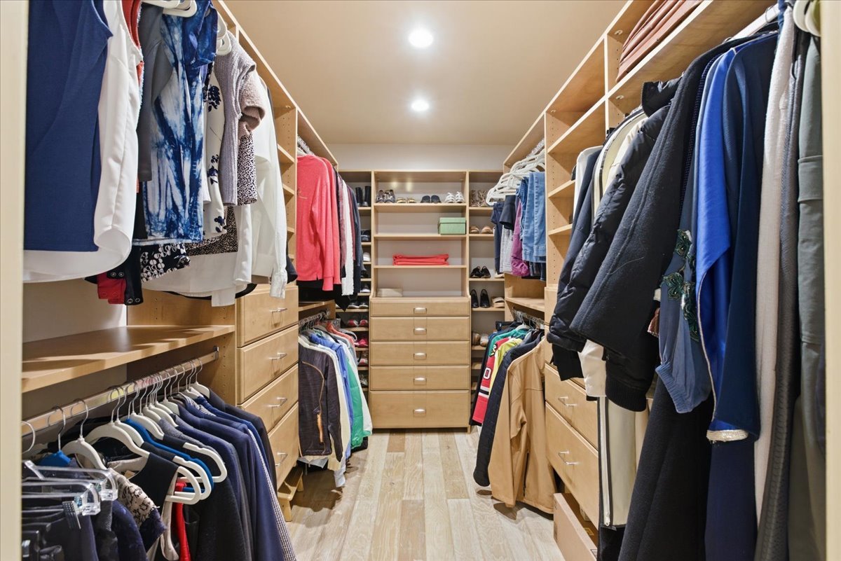 39 Mockingbird Lane Oak Brook, IL 60523 - Photo 32 of 57 a view of walk in closet with clothes and shoes
