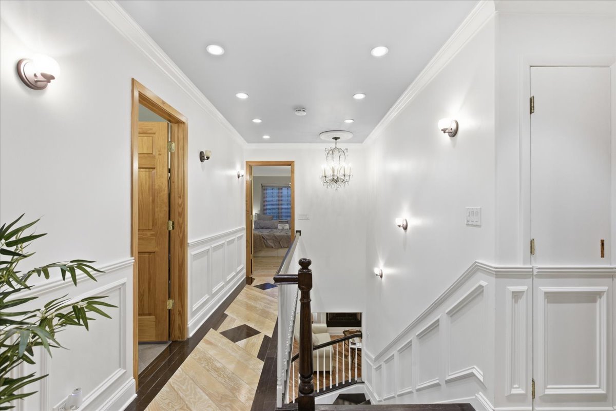 39 Mockingbird Lane Oak Brook, IL 60523 - Photo 36 of 57 a view of a hallway with wooden floor and staircase