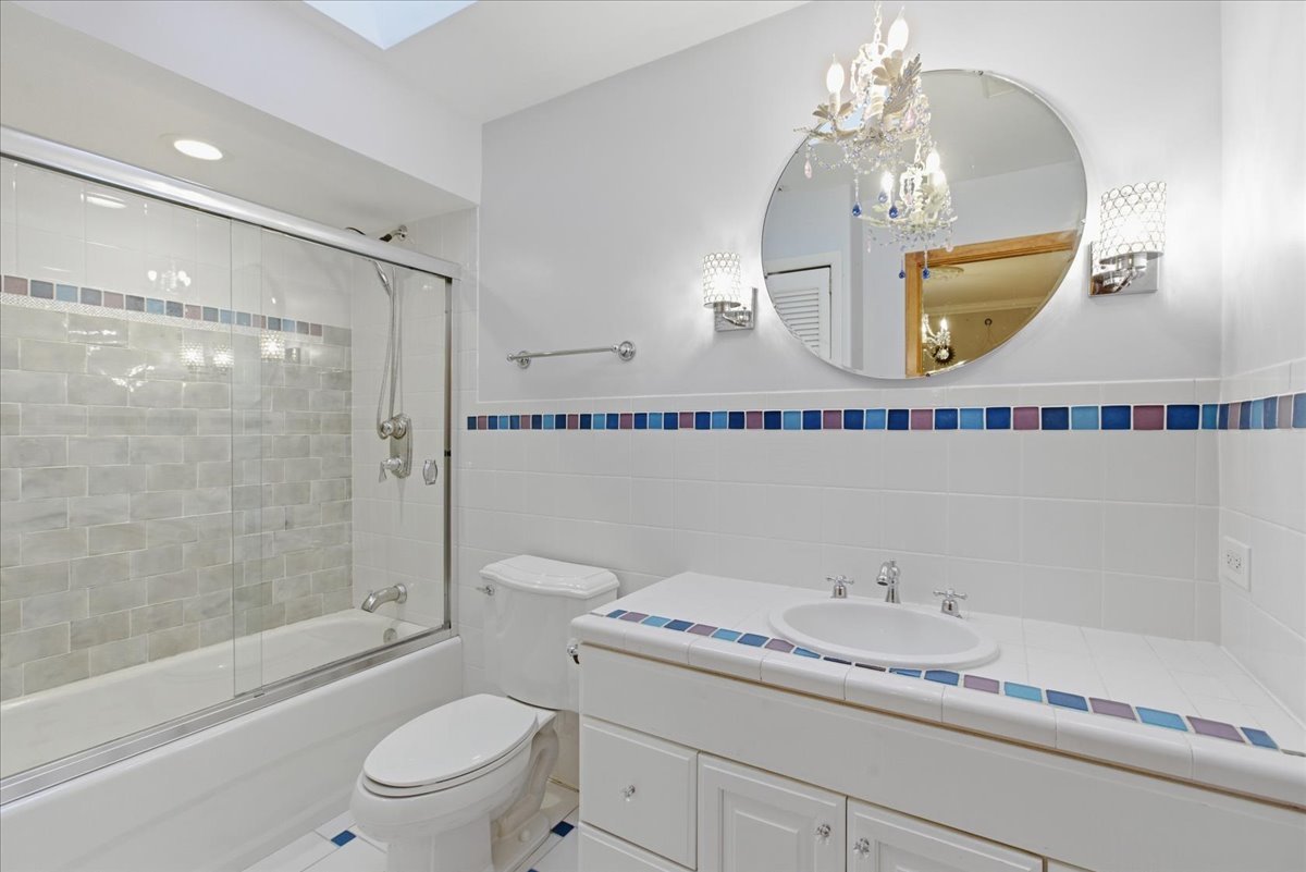 39 Mockingbird Lane Oak Brook, IL 60523 - Photo 38 of 57 a bathroom with a granite countertop sink mirror toilet and bathtub
