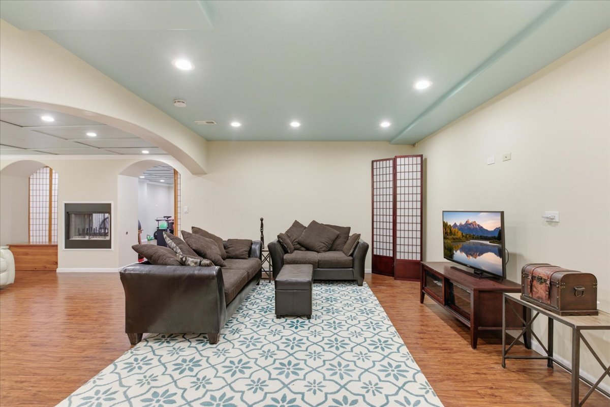 39 Mockingbird Lane Oak Brook, IL 60523 - Photo 48 of 57 a living room with furniture a flat screen tv and wooden floor