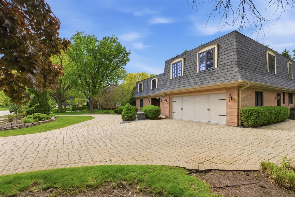 39 Mockingbird Lane Oak Brook, IL 60523 - Photo 51 of 57 a front view of a house with a yard and trees