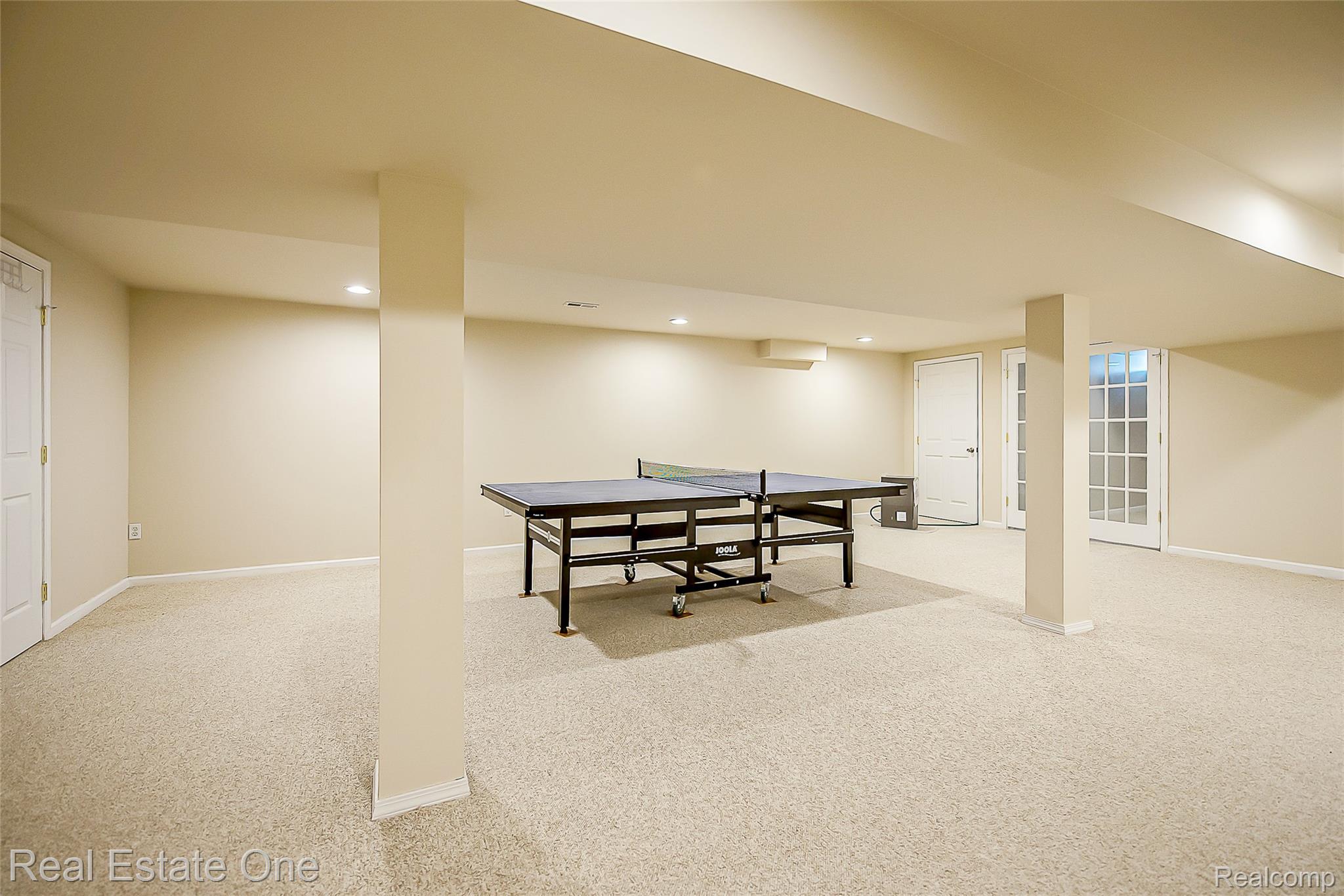 1013 Rochelle Park Drive Rochester, MI 48307 - Photo 47 of 74 Spacious lower level featuring light-toned carpeting, recessed lighting, and support columns