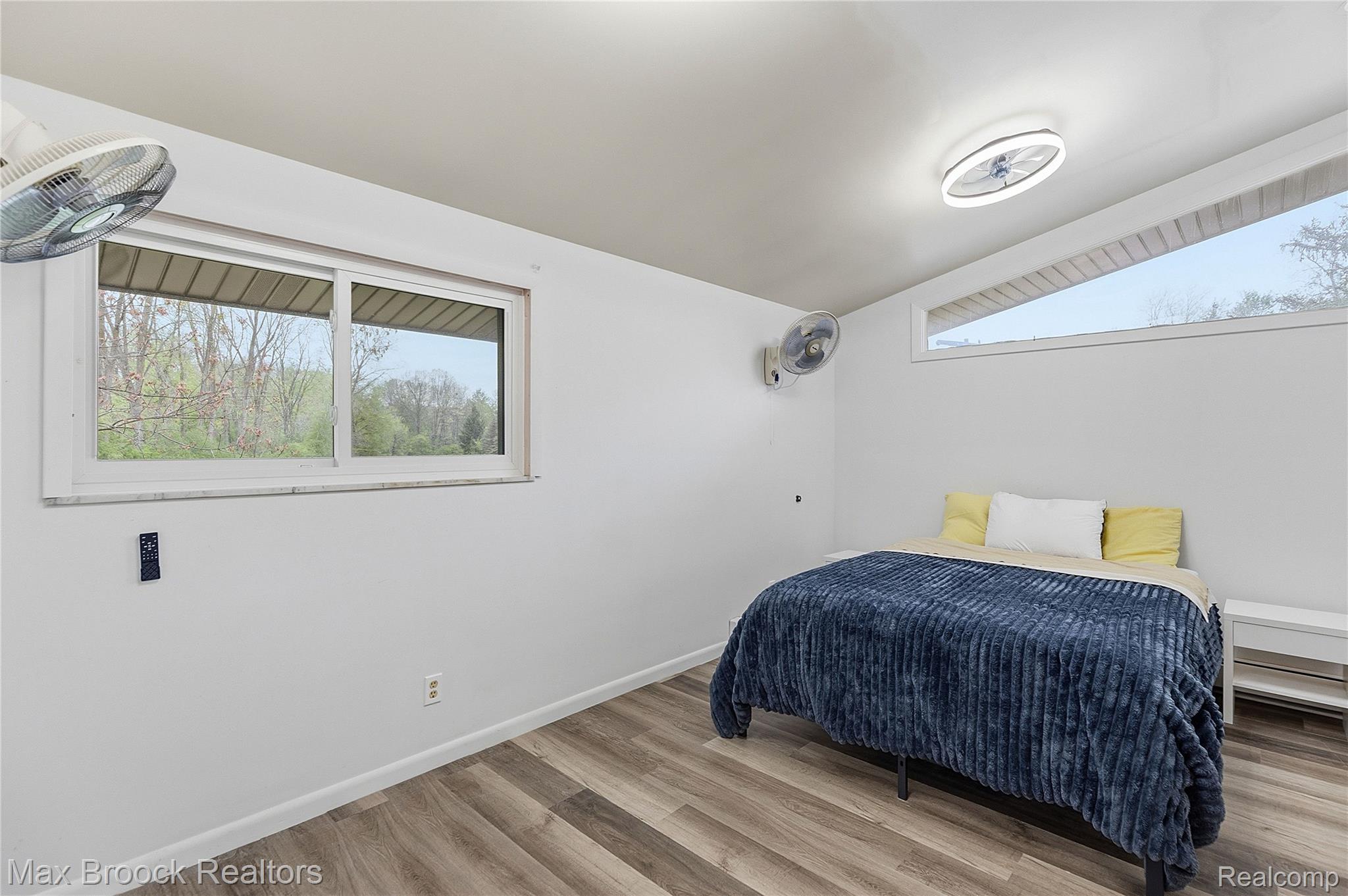1392 Maple Grove Road Lapeer, MI 48446 - Photo 25 of 70 Bedroom featuring multiple windows, light wood-type flooring, and vaulted ceiling