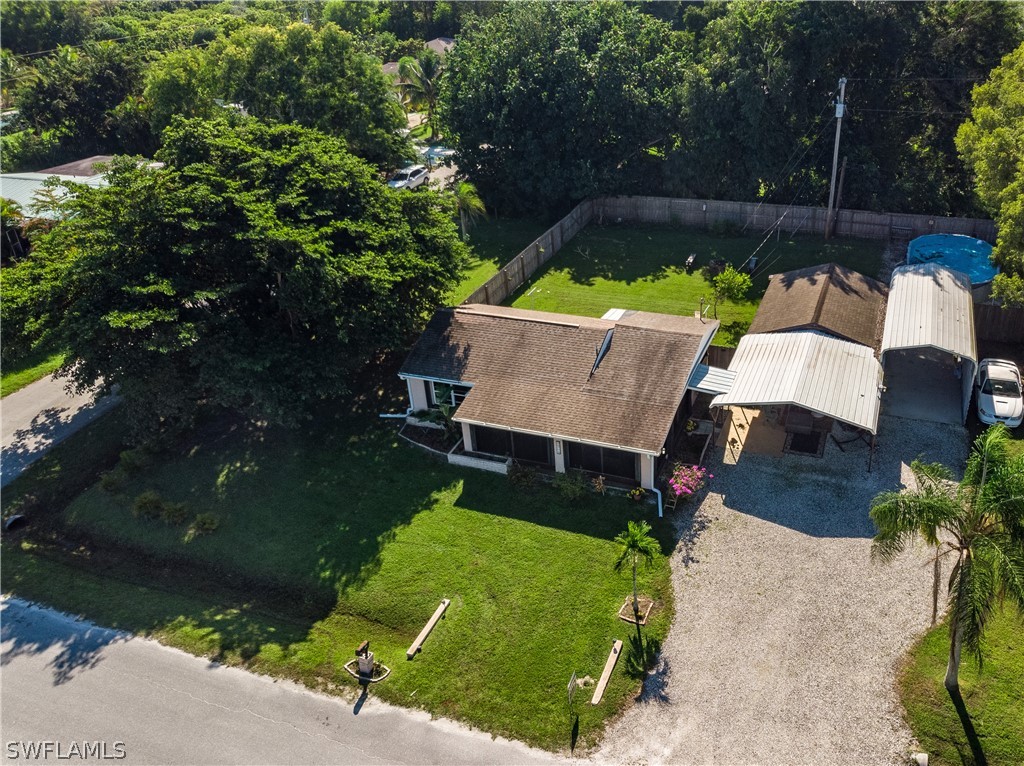 an aerial view of a house with backyard garden and patio